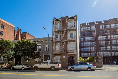 A street view of a city with cars and buildings.