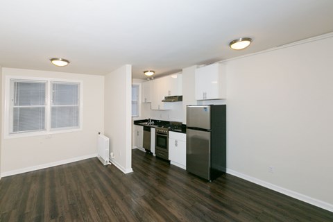 A kitchen with black countertops and white cabinets.