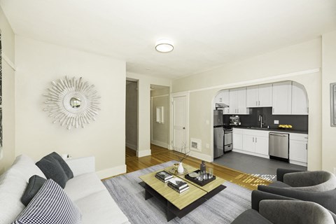 A modern living room with a white sofa and a coffee table.