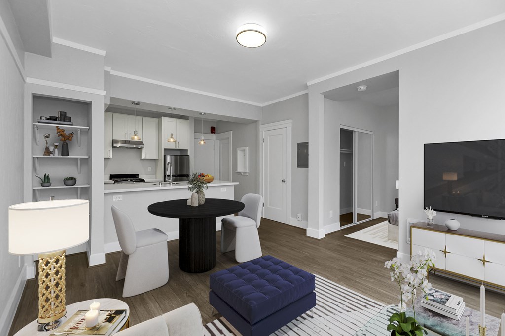 A modern living room with a black table and white chairs.