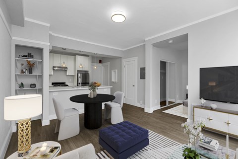 A modern living room with a black table and white chairs.