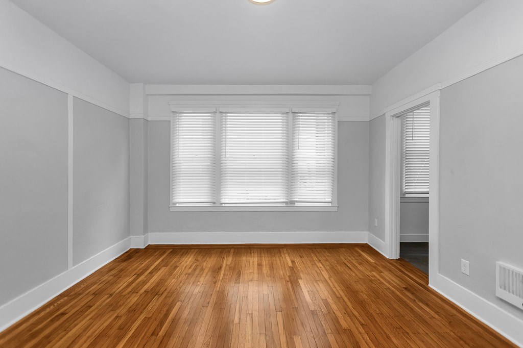 A room with wooden floors and white walls.