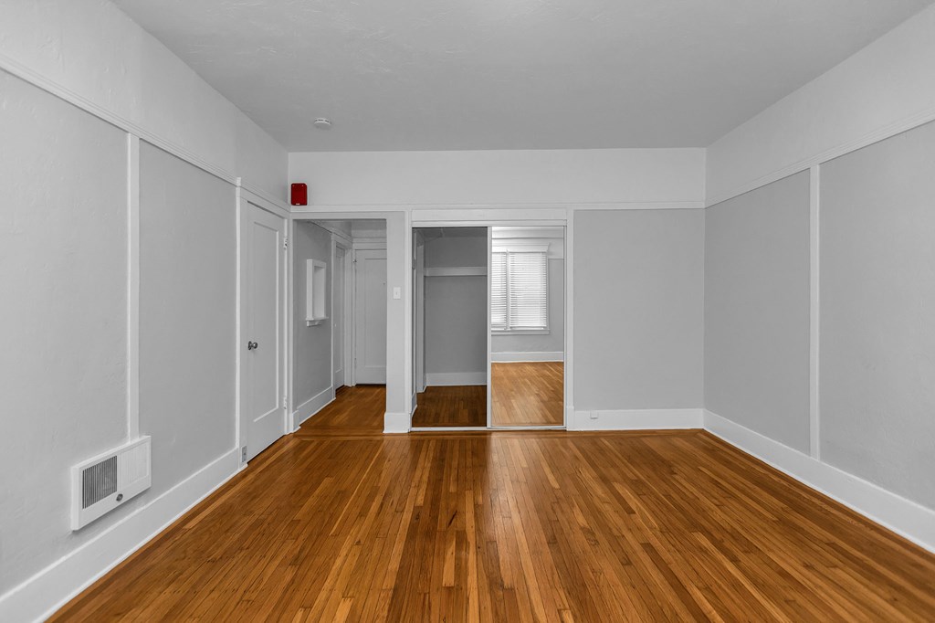 A room with wooden floors and white walls.