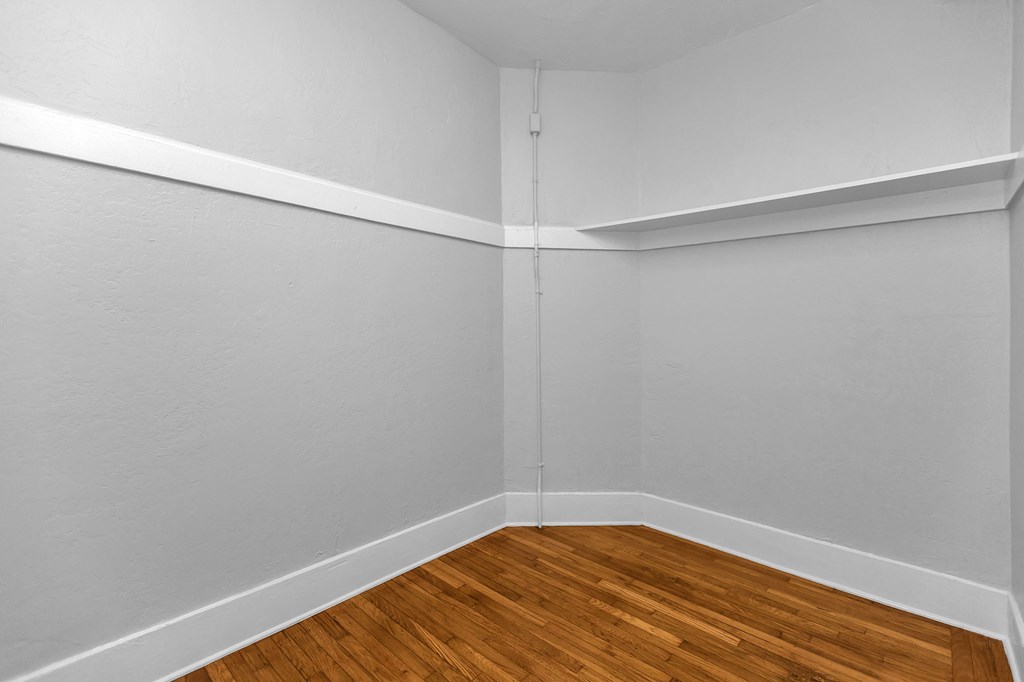 A room with a wooden floor and white walls.