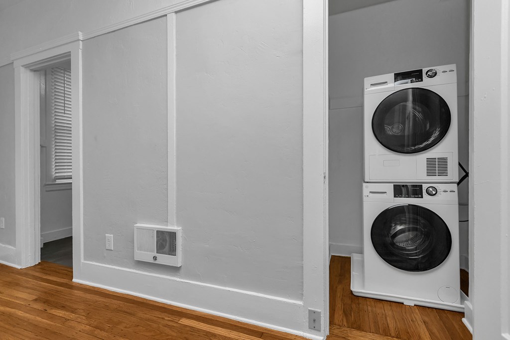 A white dryer is in a laundry room.
