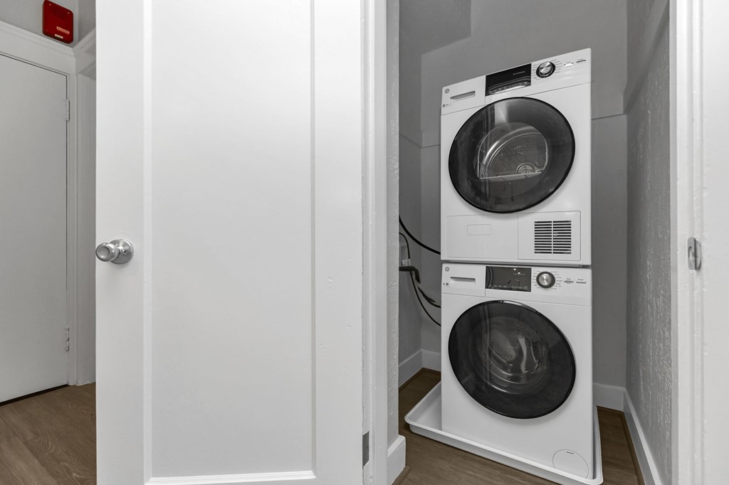 A white washing machine is in a small room.