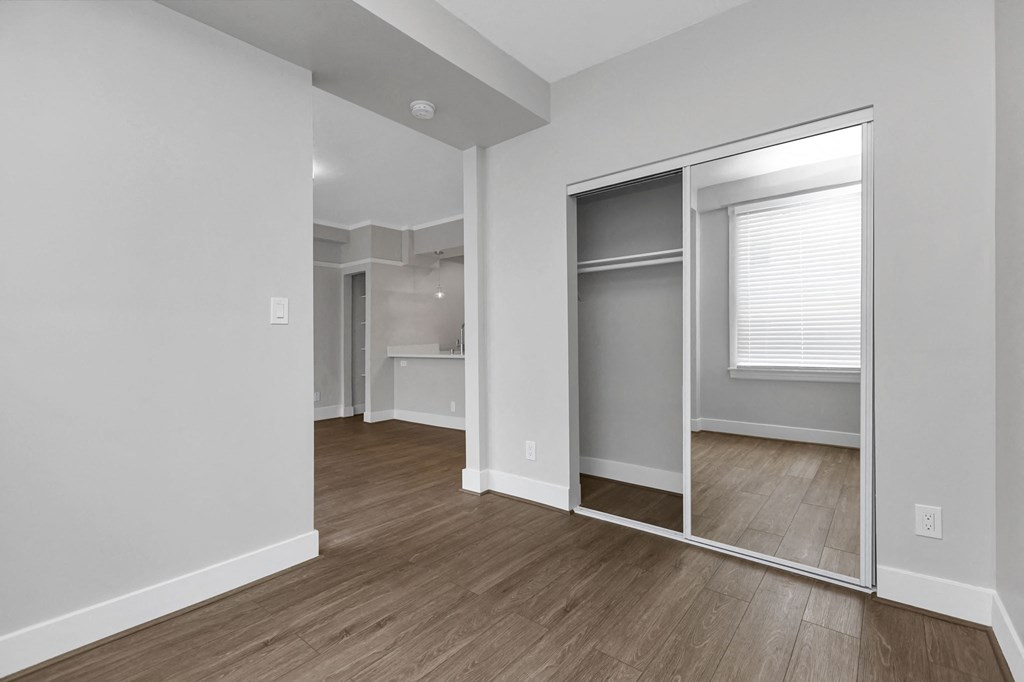 A room with a sliding door and a window.