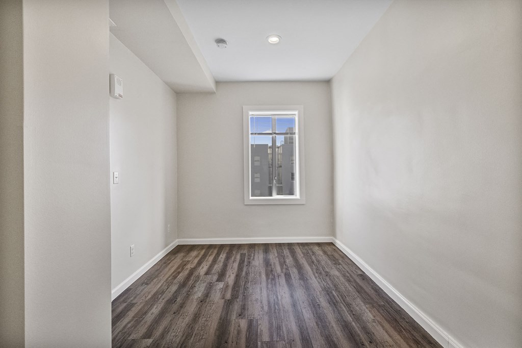 A room with wooden floors and a window.