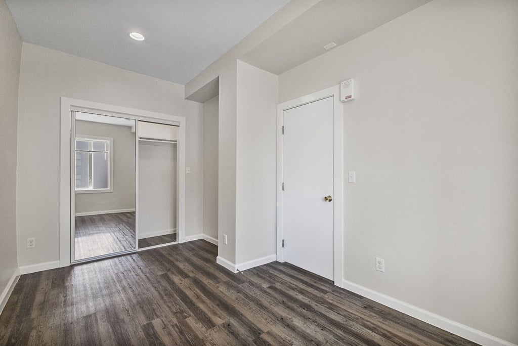 A room with a white door and a window with a white frame.