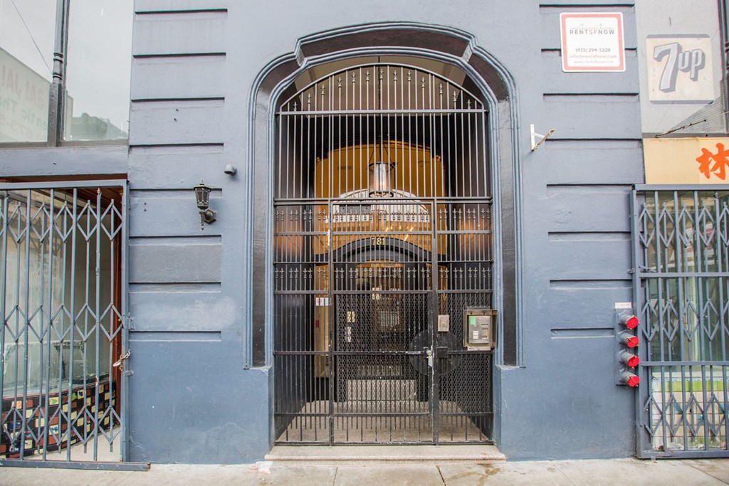 A blue building with a large gate and a sign that says 7-11.