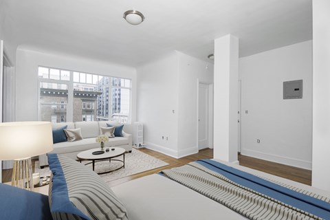 A living room with a white couch and a coffee table.
