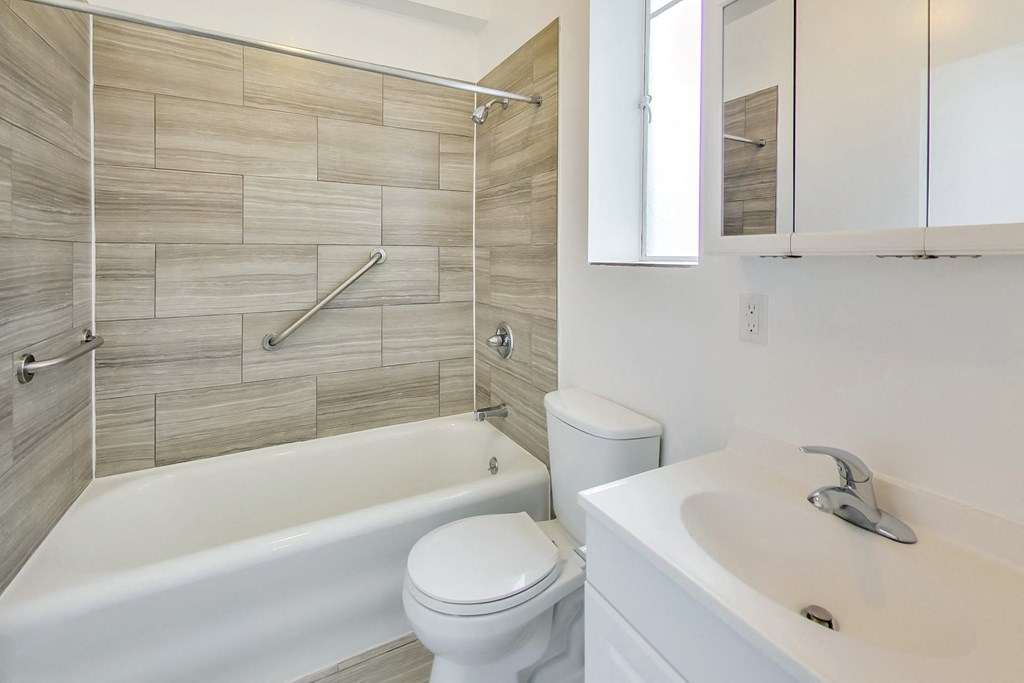 a bathroom with a tub and a toilet and a sink