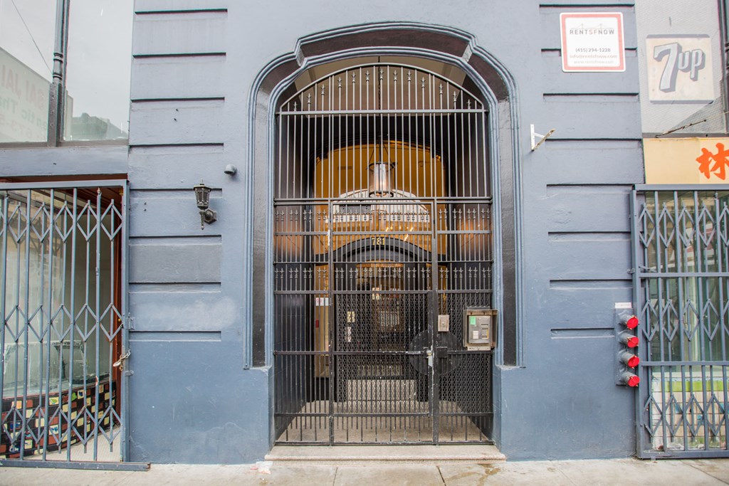 A blue building with a large gate and a sign that says 7-11.