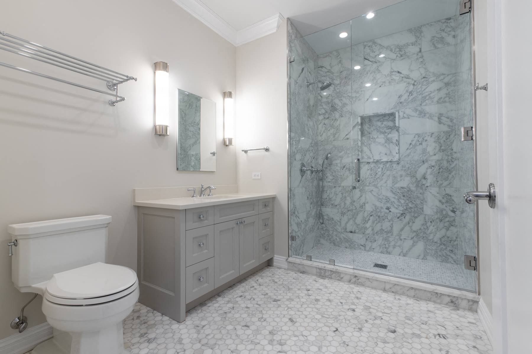a white bathroom with a shower and a toilet and a sink