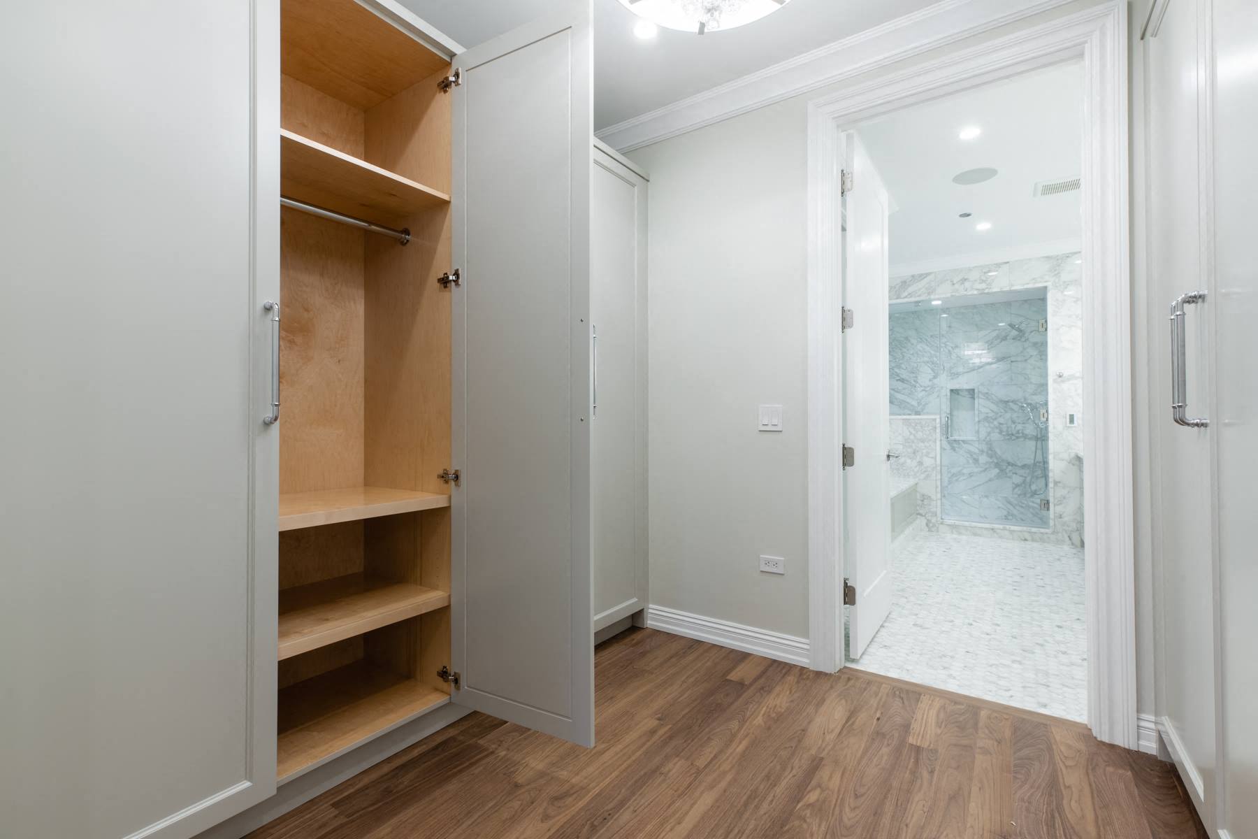 a small bathroom with a closet and a mirror