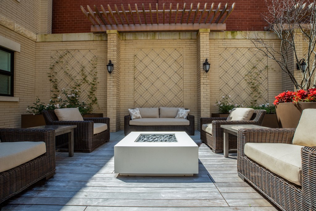 a patio with couches and chairs and a coffee table