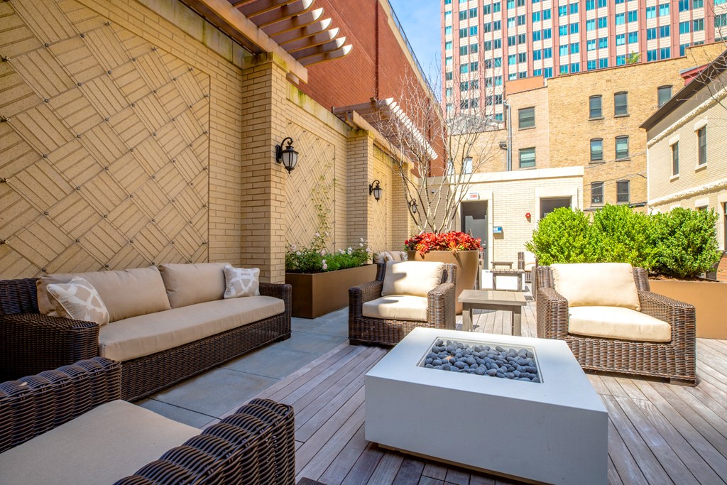a patio with furniture and a fire pit
