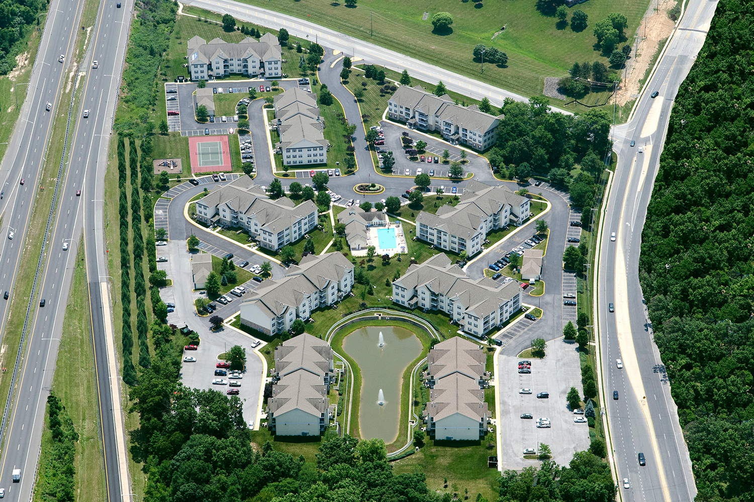 an aerial view of a neighborhood of houses and a highway