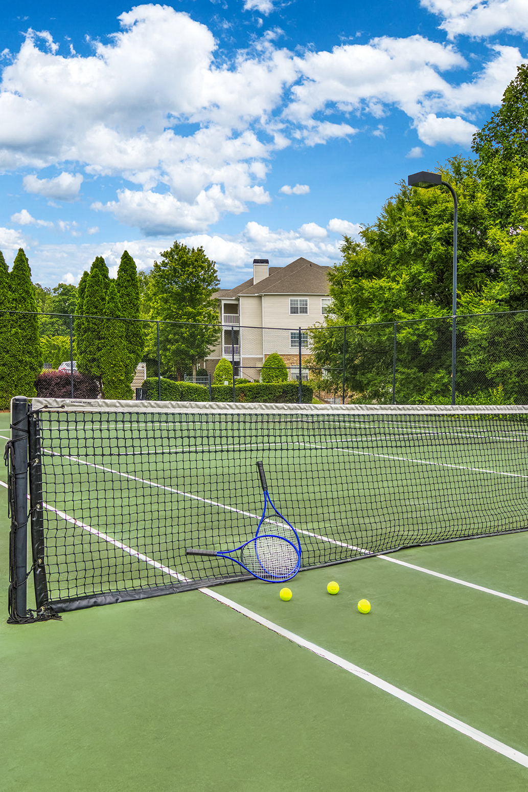 a tennis court with a racket and balls on it