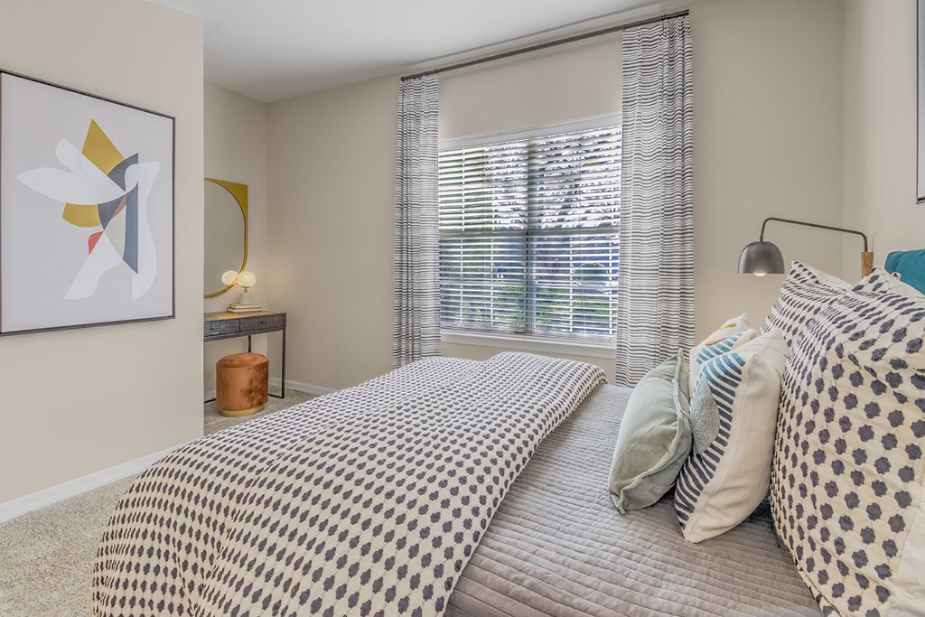 a bedroom with a large bed and a window