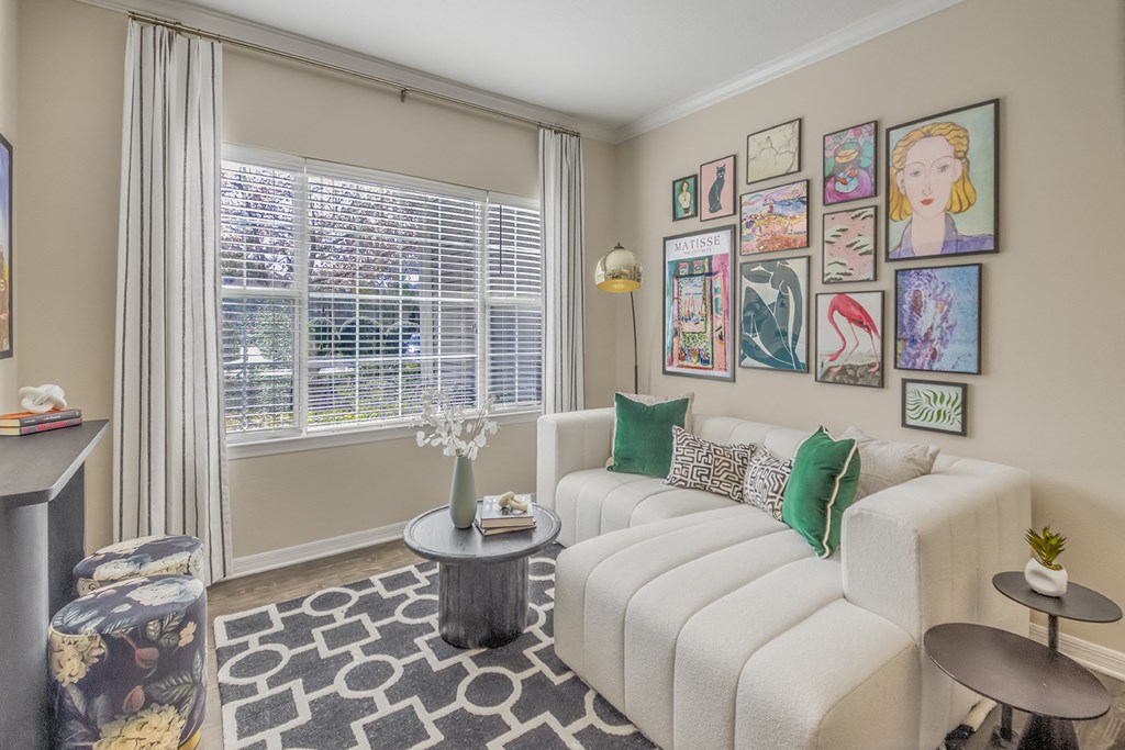 a living room with a white couch and a window