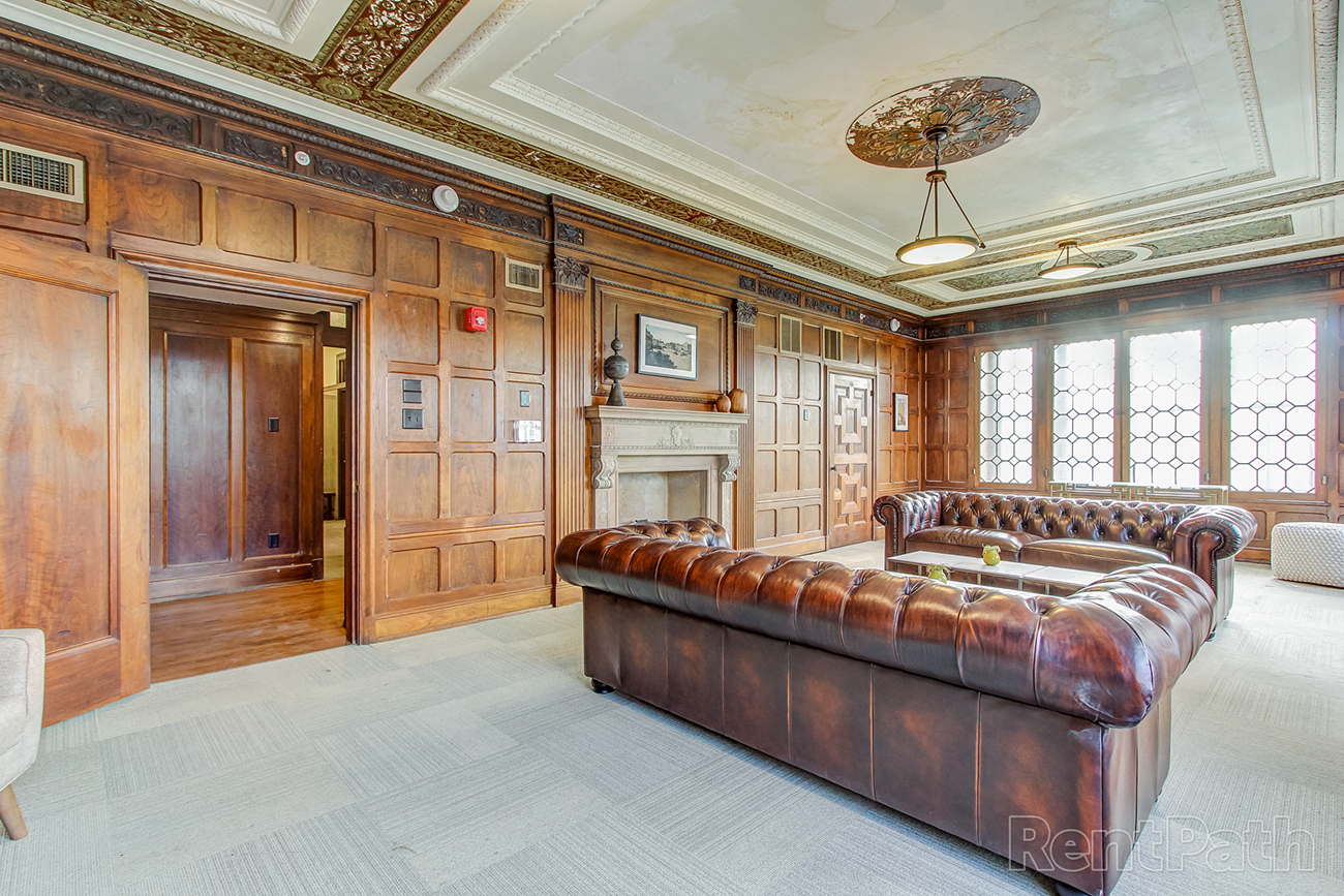 a large living room with leather furniture and a fireplace