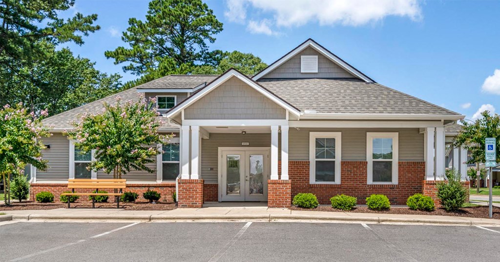 the front exterior of a brick house with a porch