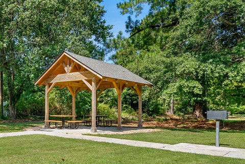 a pavilion with a picnic table in a park