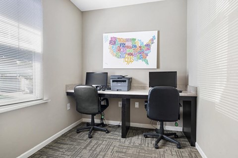 an office with two desks and two chairs and a printer