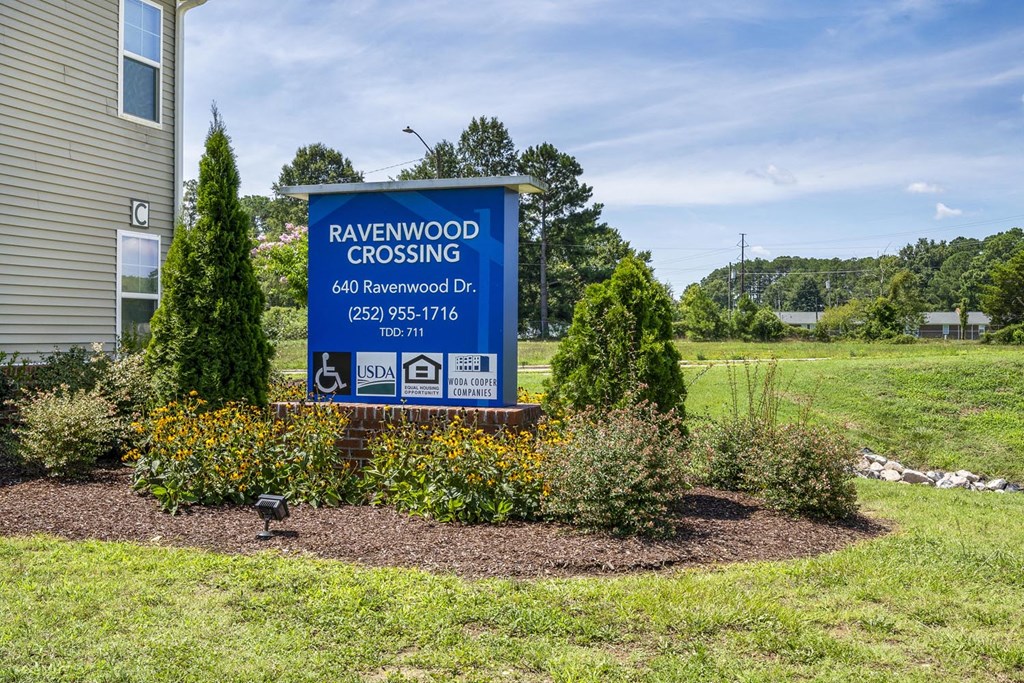 the sign crossing in front of a house