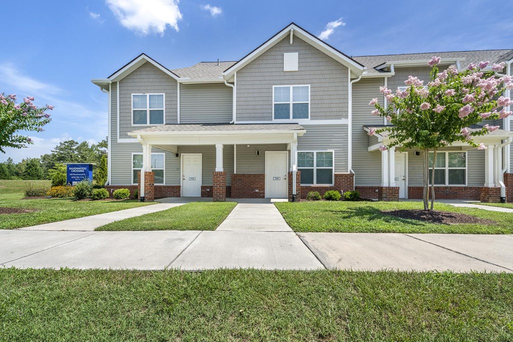 a large house with a sidewalk in front of it