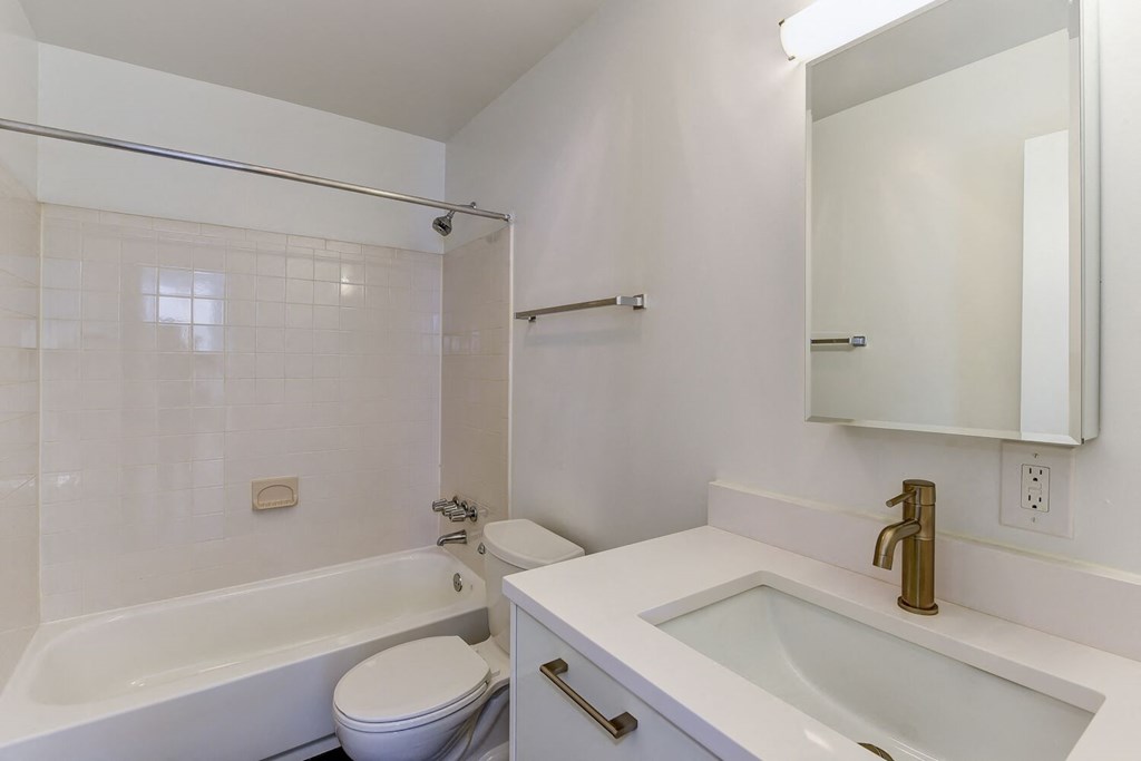 a bathroom with a sink toilet and a bath tub
