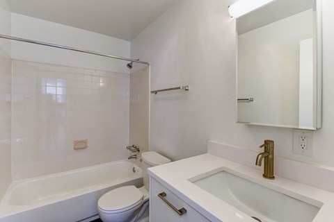 a bathroom with a sink toilet and a bath tub