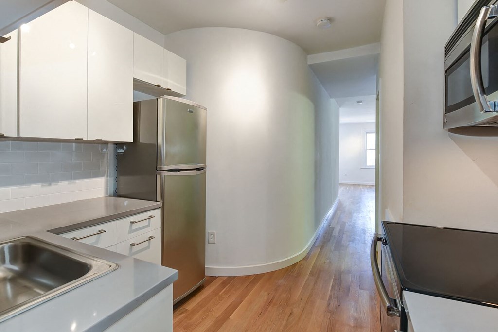 a kitchen with stainless steel appliances and white cabinets
