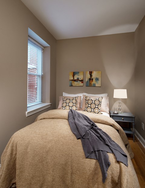 a bedroom with a bed and a window