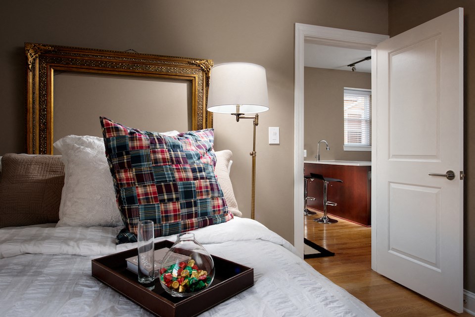 a bedroom with a bed with a tray on top of it