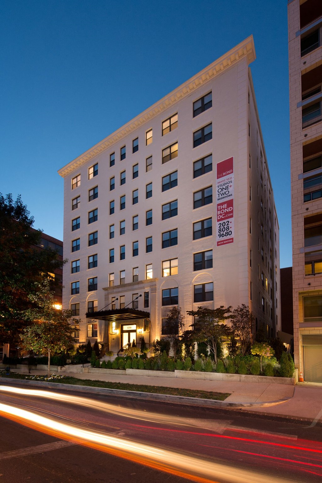 a tall building with a street in front of it at night