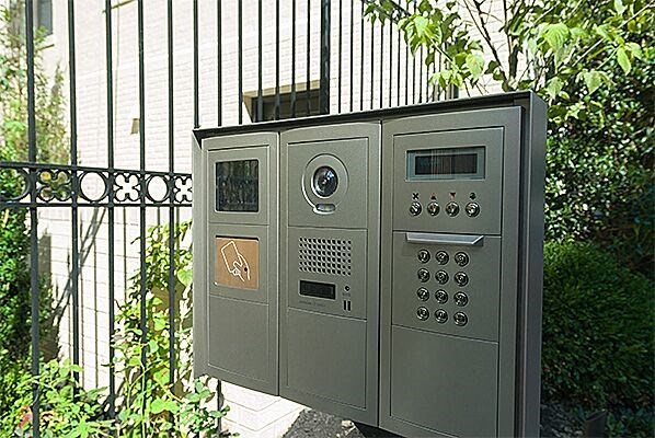 a microwave oven sitting in front of a fence