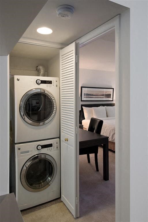 a small bathroom with a washing machine and a dryer in it