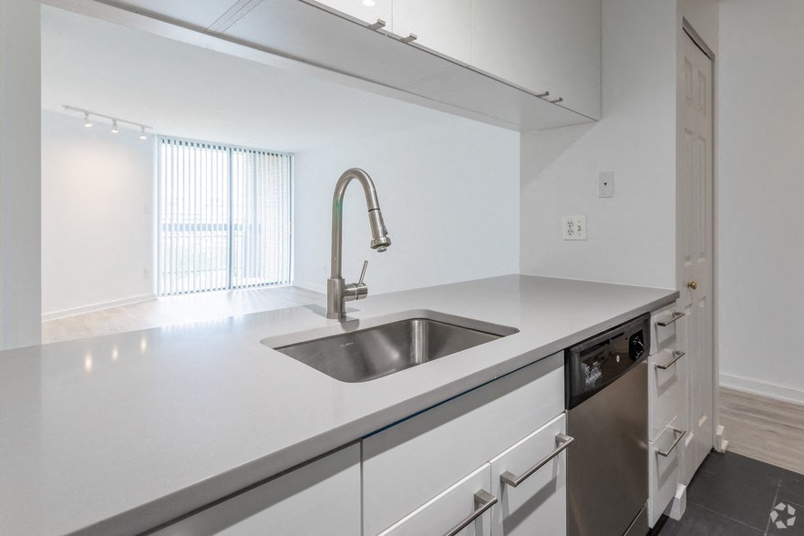 an empty kitchen with a sink and a window