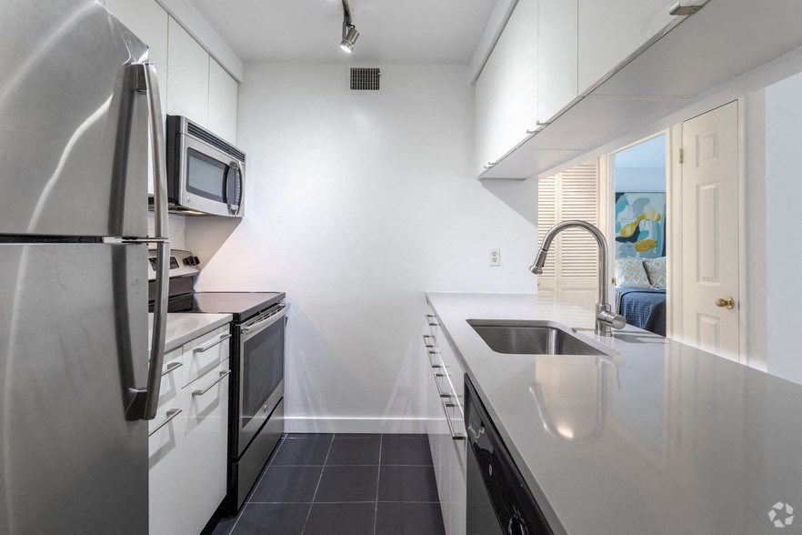 a kitchen with a sink and a refrigerator