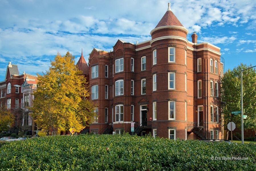 a large brick building with a tree in front of it