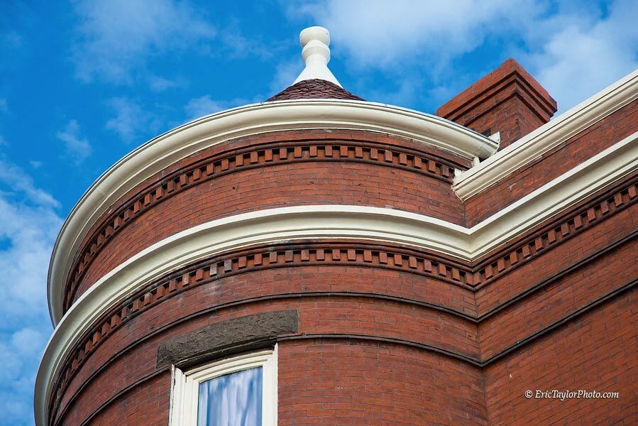 a brick building with a domed top and a blue sky