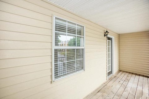 a room with a window and a wooden floor