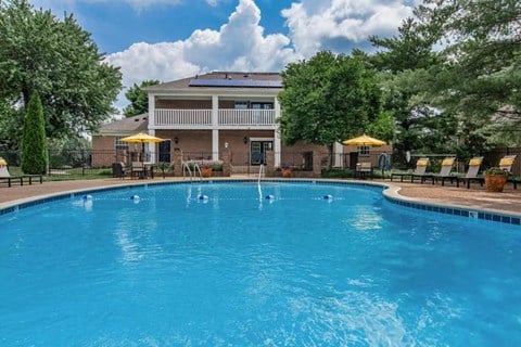 a large blue swimming pool in front of a house