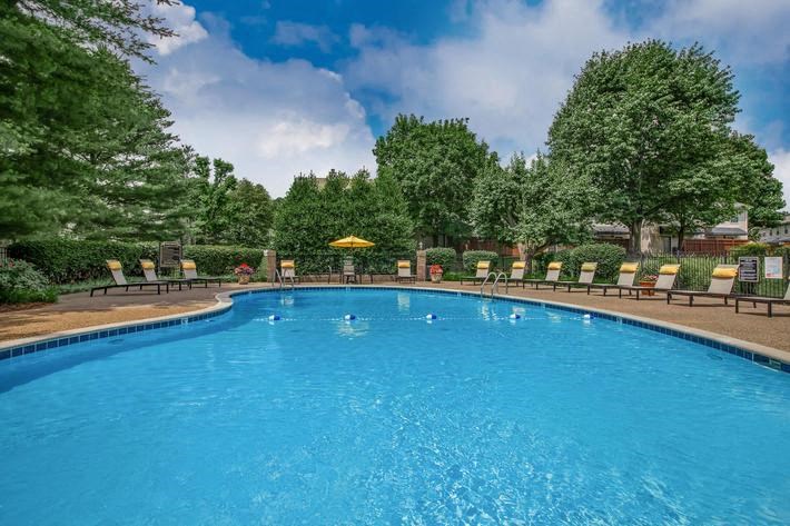 a large swimming pool with chairs around it