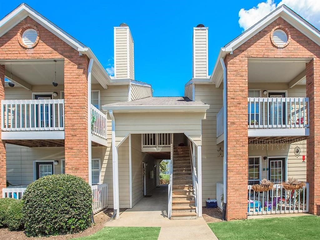 the front of a building with a porch and a staircase