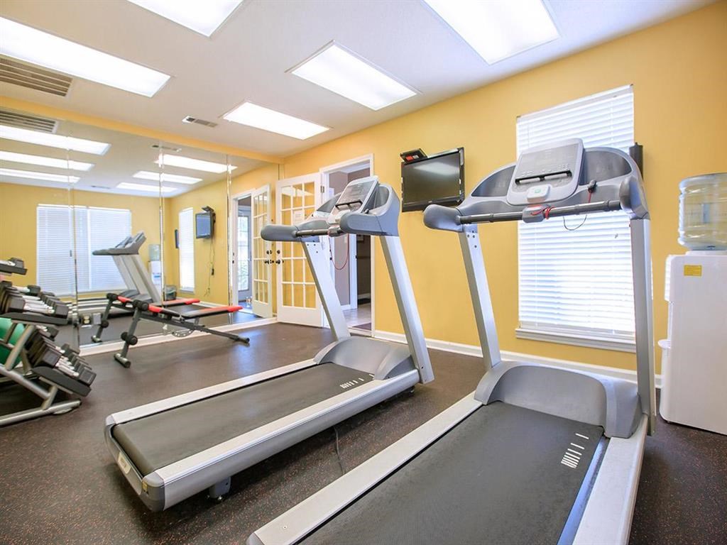a gym with treadmills and other exercise equipment