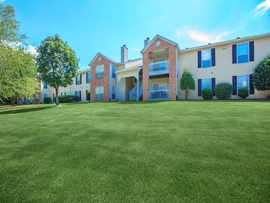 a large lawn in front of an apartment building