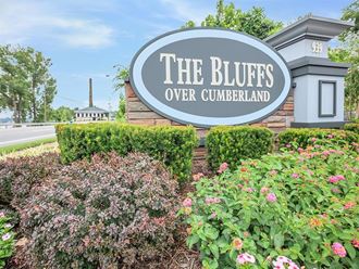 the bluffs sign in front of flowers and bushes